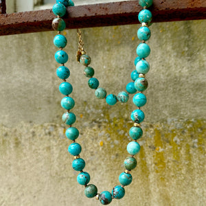 Turquoise necklace using 10mm turquoise beads and 5mm gold filled rondel beads. Strung onto a beige silk thread and using a gold filled clasp. 