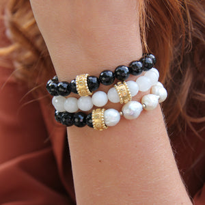 three gemstone bracelets with black onyx, freshwater pearls, and gold vermeil imparting empowering qualities