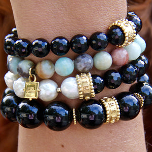 stack of gemstone bracelets with pearls, black onyx, amazonite and gold vermeil
